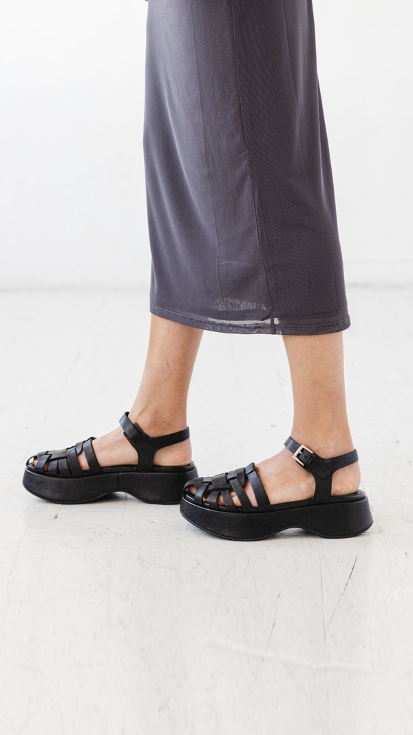 platform fisher black leather sandal with buckle strap on foot