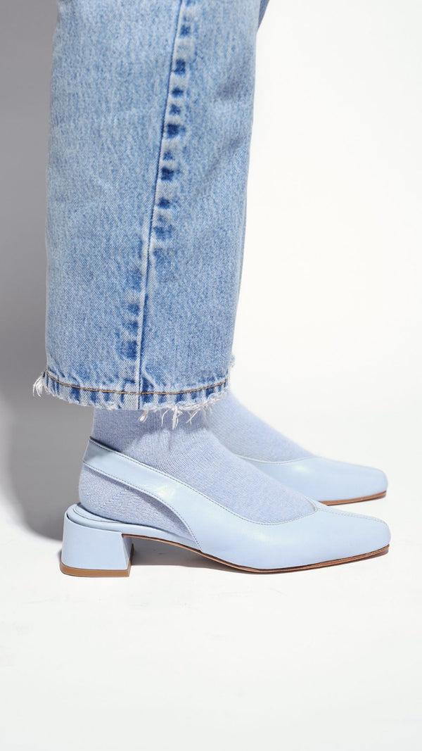 minimalist slingback block heeled pump in sky baby blue leather on the foot with socks