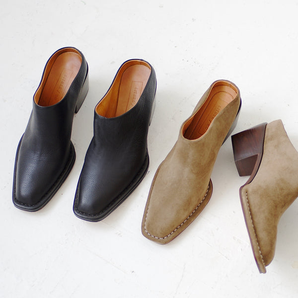 Pair of black and brown ankle boots on a white background
