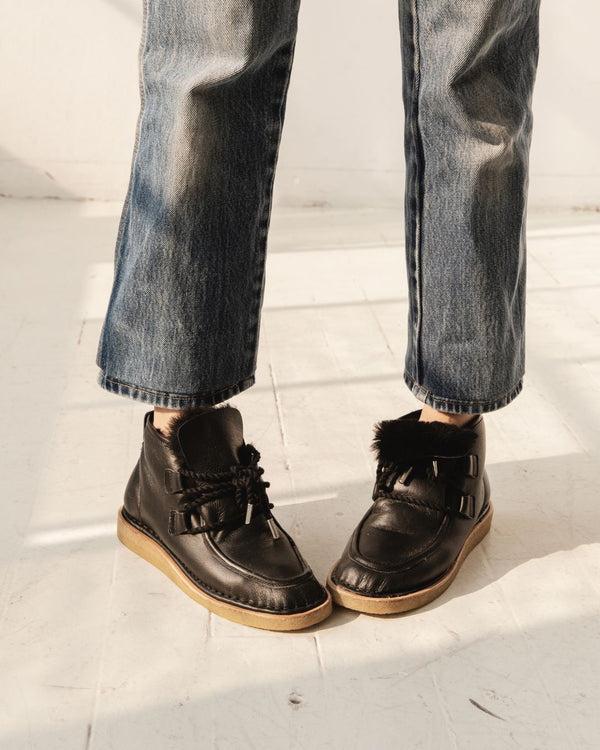 black leather lace up shearling moccasin boot crepe sole premium front view on foot