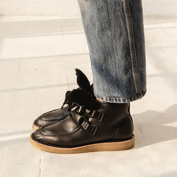 black leather lace up shearling moccasin boot crepe sole premium on the foot side view
