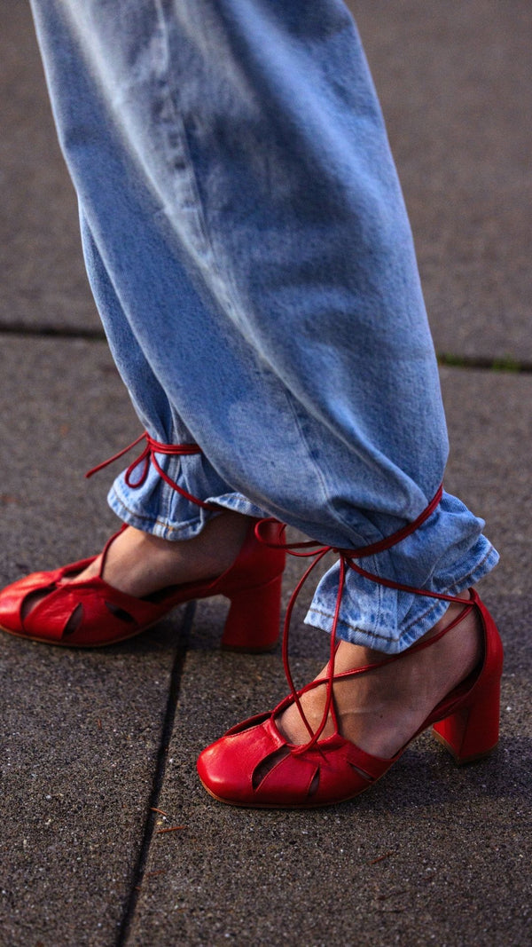 demi lace up red leather heel bow tie cage on the foot sandal close up