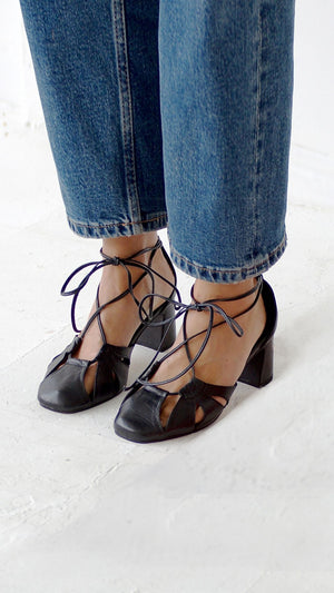 demi lace up heel in black leather round toe block heel on the foot