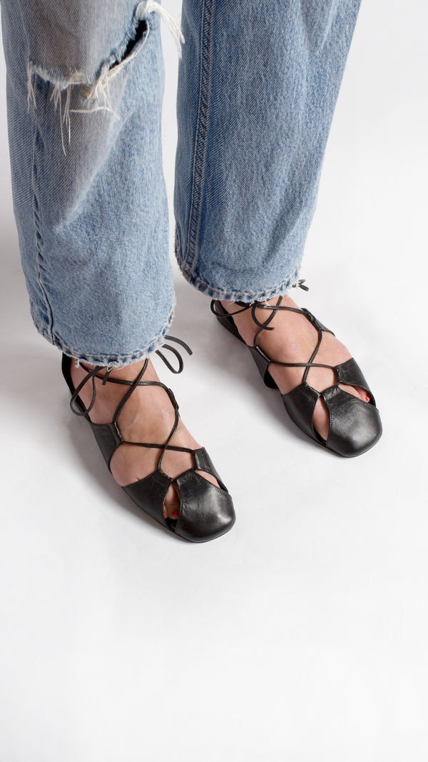 ghillie lace up black leather lace up cage flats sandals on the foot