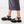 platform fisher black leather sandal with buckle strap on foot