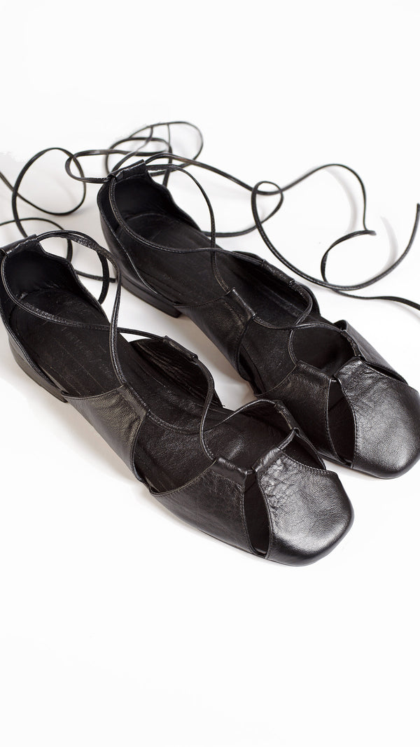 ghillie lace up black leather lace up cage flats sandals top down view